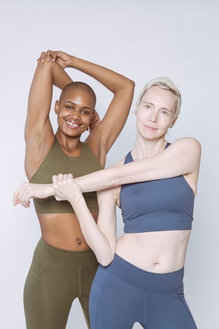 Three diverse women practicing a gentle yoga pose together in a bright, sunlit studio.